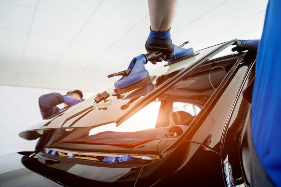 Auto glass technician fitting a windshield